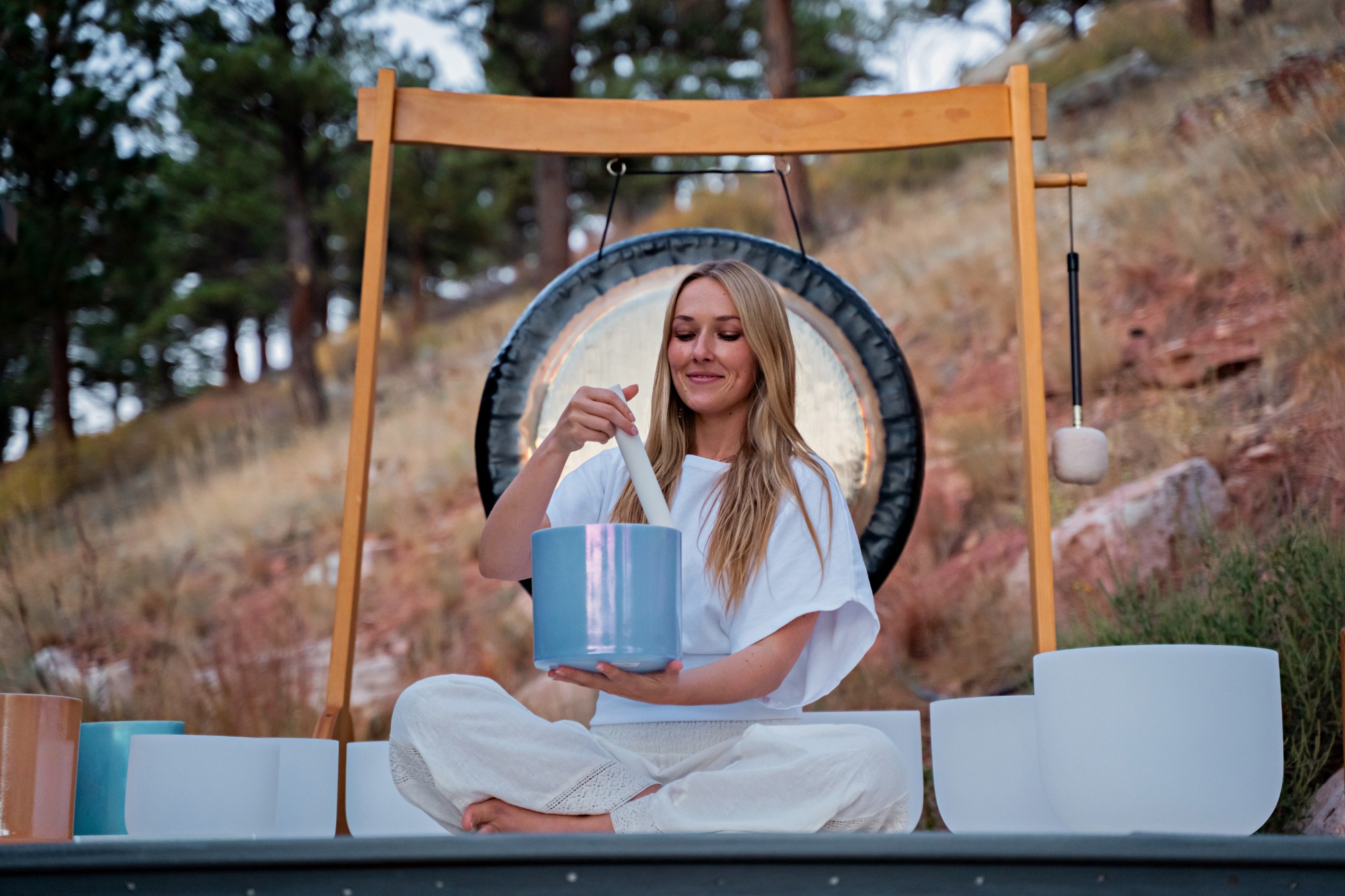Marley Marina playing a blue crystal singing bowl
